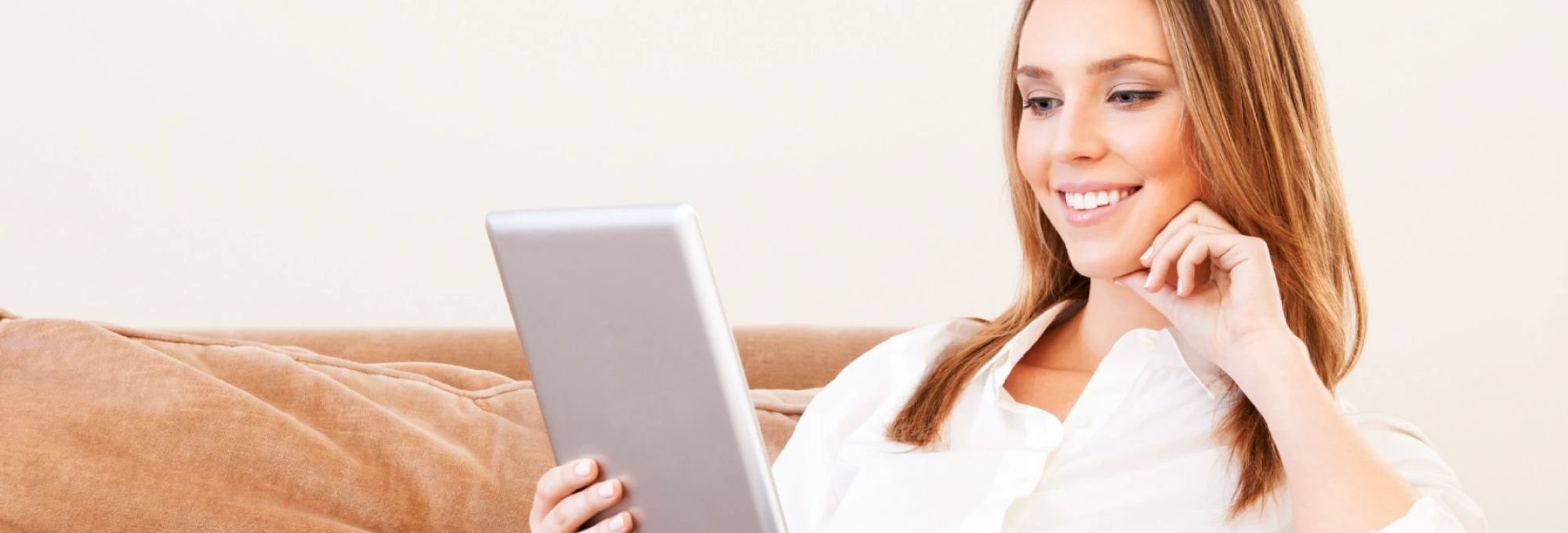 Woman browsing Internet on a tablet for floor products from Direct Sales Floors in Danville, CA